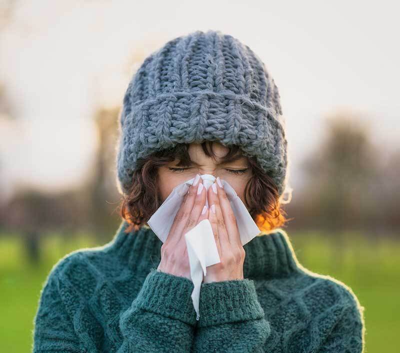 Woman sneezing