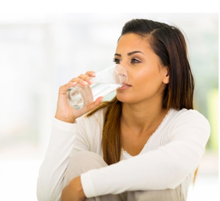 woman drinking a glass of water